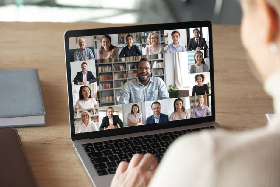 Laptop screen with people on a videoconference